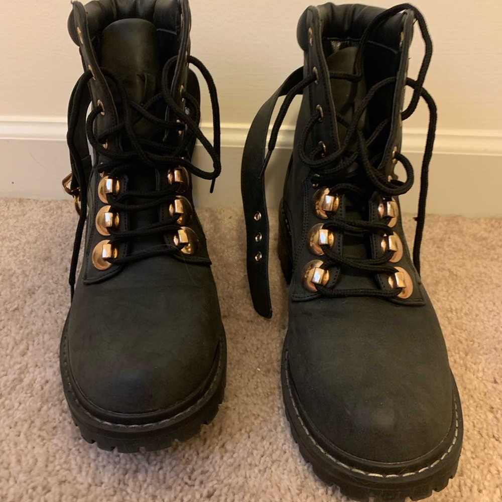 Black combat boots with gold details